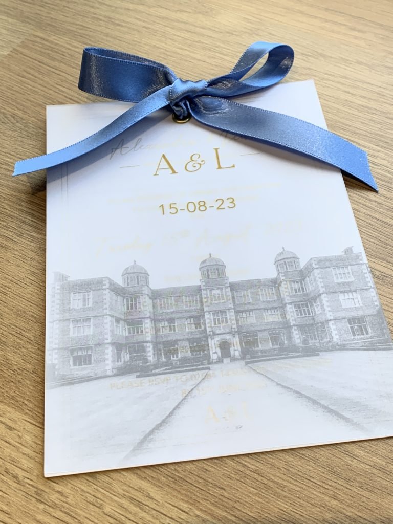 Wedding invitation with vellum overlay incorporating wedding venue photo